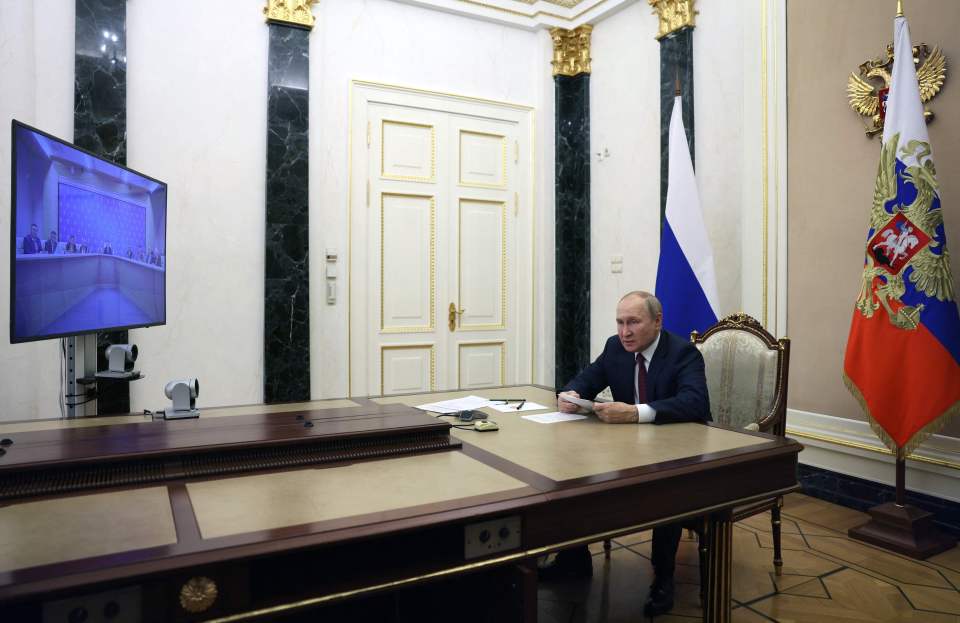 The Russian President pictured during a meeting with intelligence chiefs yesterday