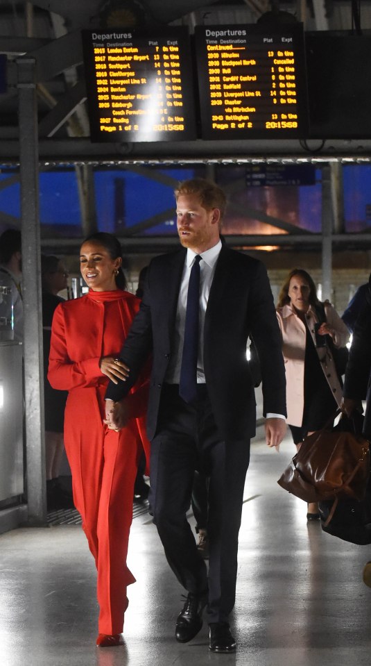 The couple at Manchester Piccadilly train station following Meghan's speech