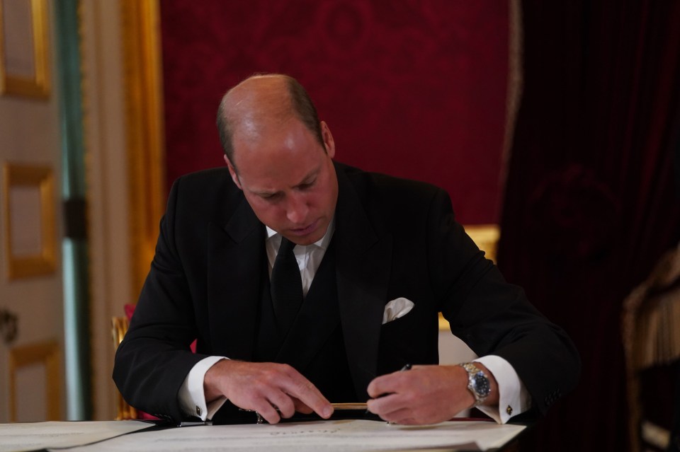 The new Prince of Wales signs the oath to uphold the security of the Church in Scotland during the Accession Council