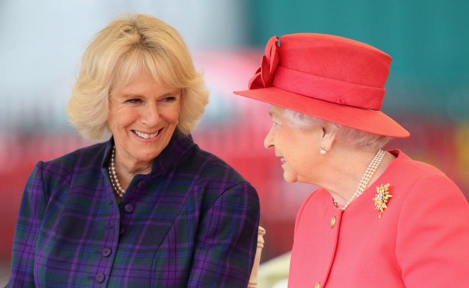 Queen Elizabeth II and Camilla, Duchess of Cornwall, share a joke as they visit a London Riding Centre in 2013