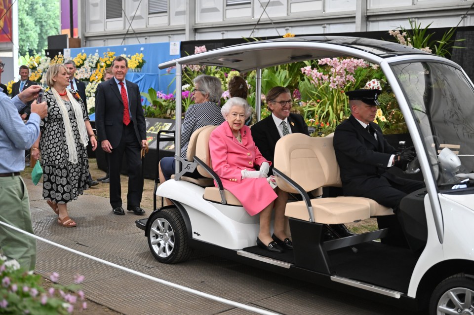 Queen Elizabeth sitting in a buggy at the Chelsea Flower Show