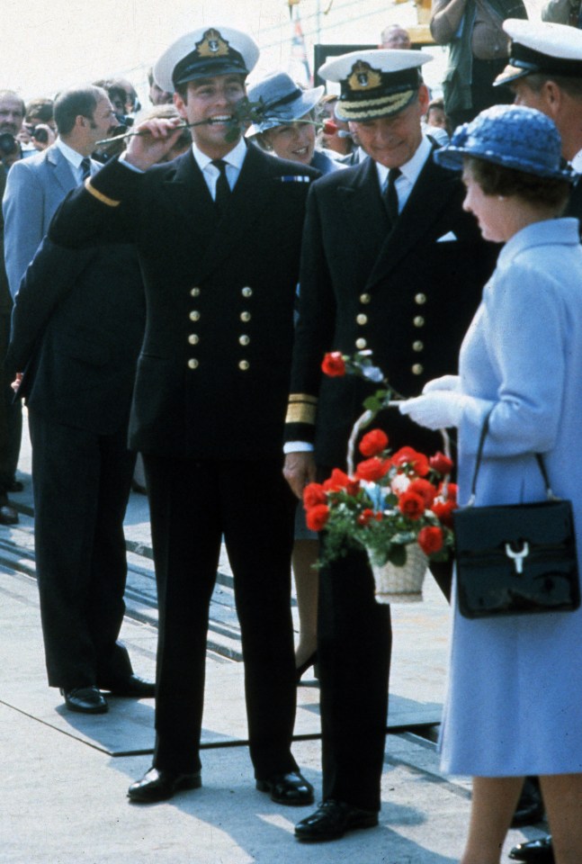 Prince Andrew in his youth with a rose between his teeth in front of the late Queen