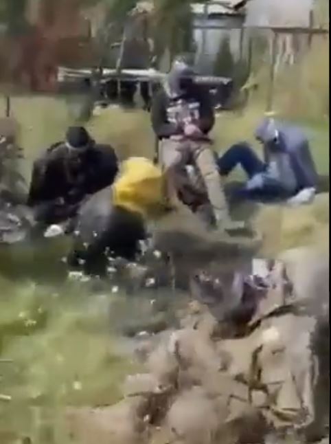 Another group of captured Russians sitting on the grass