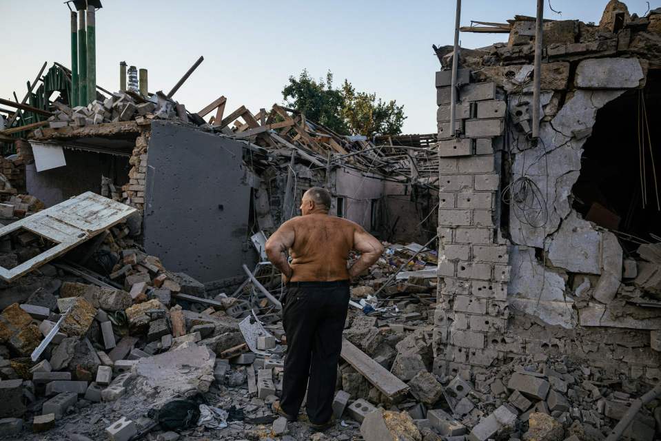 A resident in Mykolaiv, near Kherson, looks at his destroyed house following a missile strike