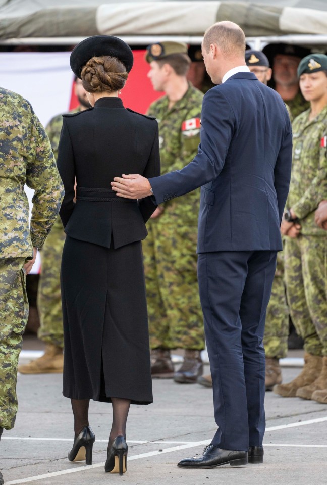 The pair put on an "unusually tactile" display as William put his hand on the small of Kate's back, according to body language expert Judi James