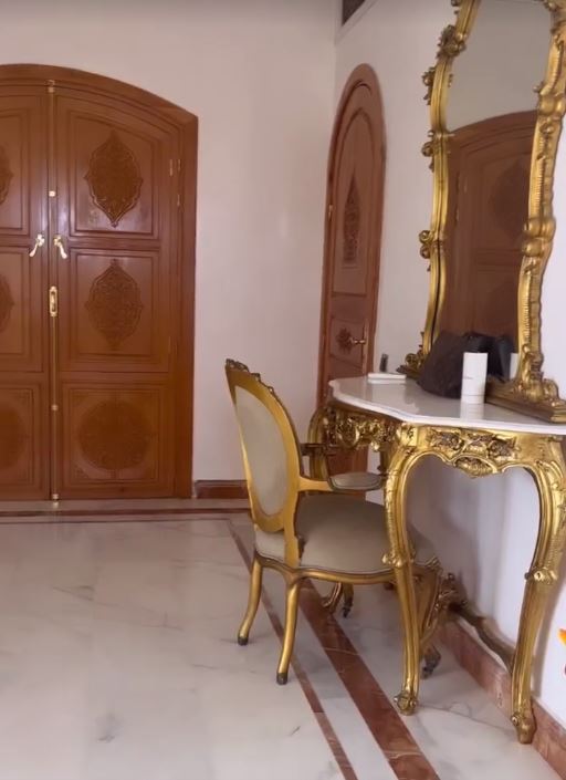 Yazmin has a huge gold dressing table and arched doors