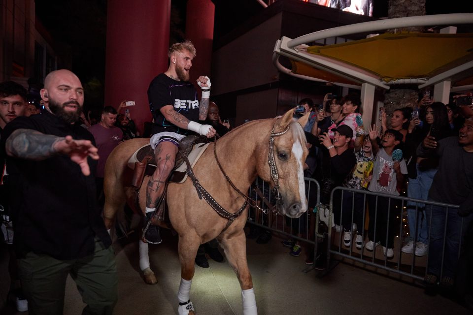 Jake Paul arriving to the open workouts on a horse