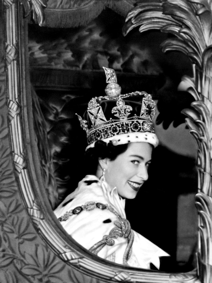 The Queen smiling to the crowd from her carriage as she left Westminster Abbey