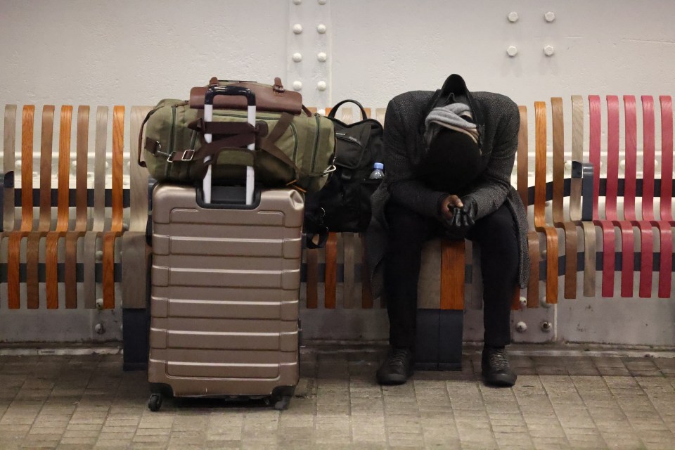 A train passenger attempting to sleep at London’s Paddington Station