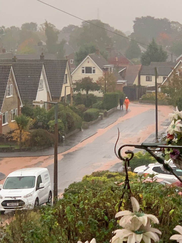 A sea of mud cascades down Orchard Close amid heavy downpours in Burton Joyce, Nottinghamshire