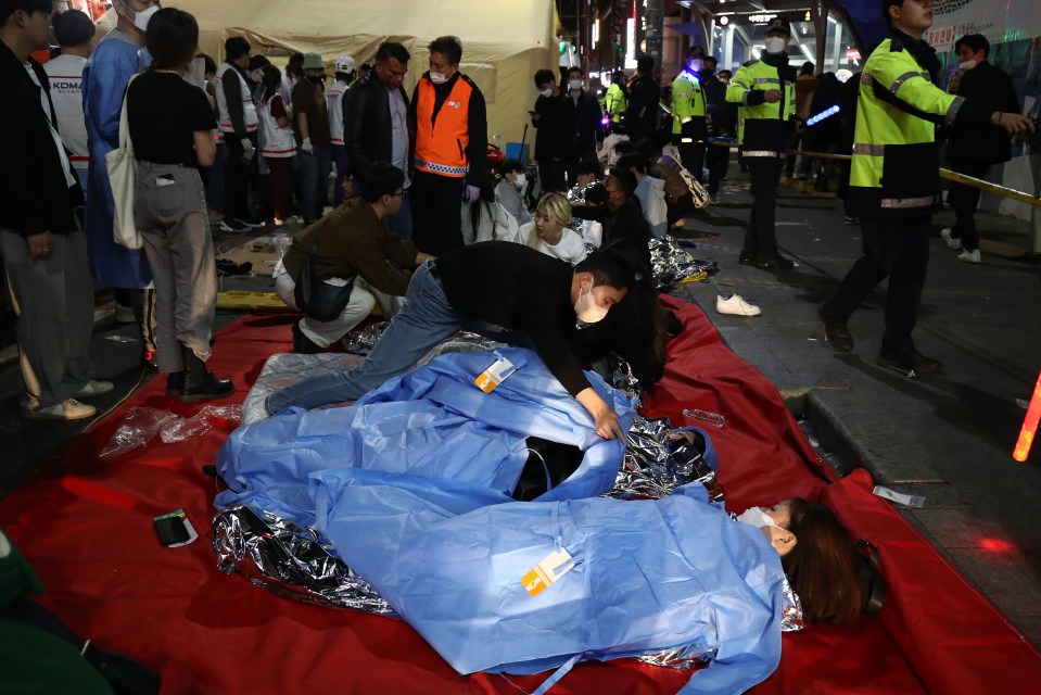 Survivors were also seen wrapped in foil blankets to stay warm following the crush