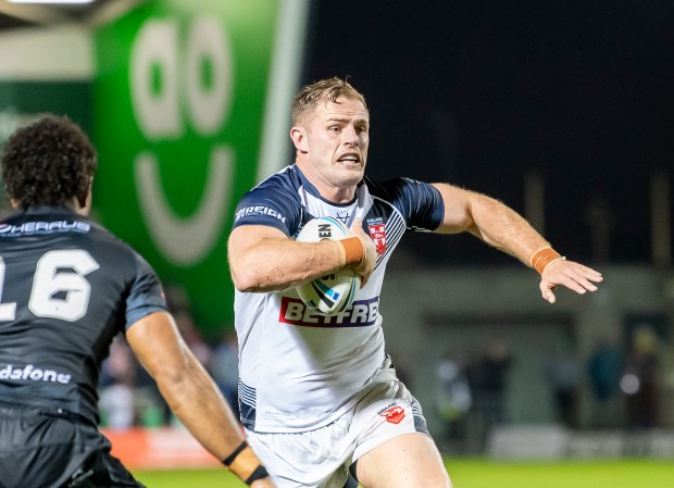 Tom Burgess of England running with the rugby ball during a match against Fiji.