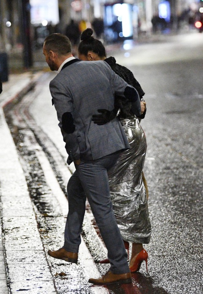 They were snapped crossing the road arm in arm