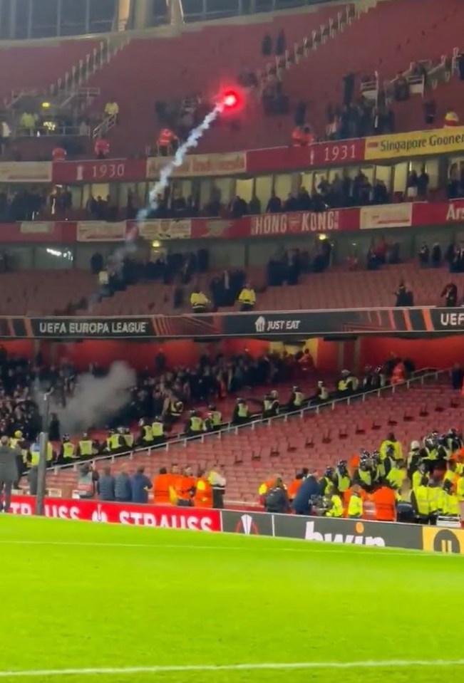 A flare was launched from the PSV end towards the Arsenal supporters