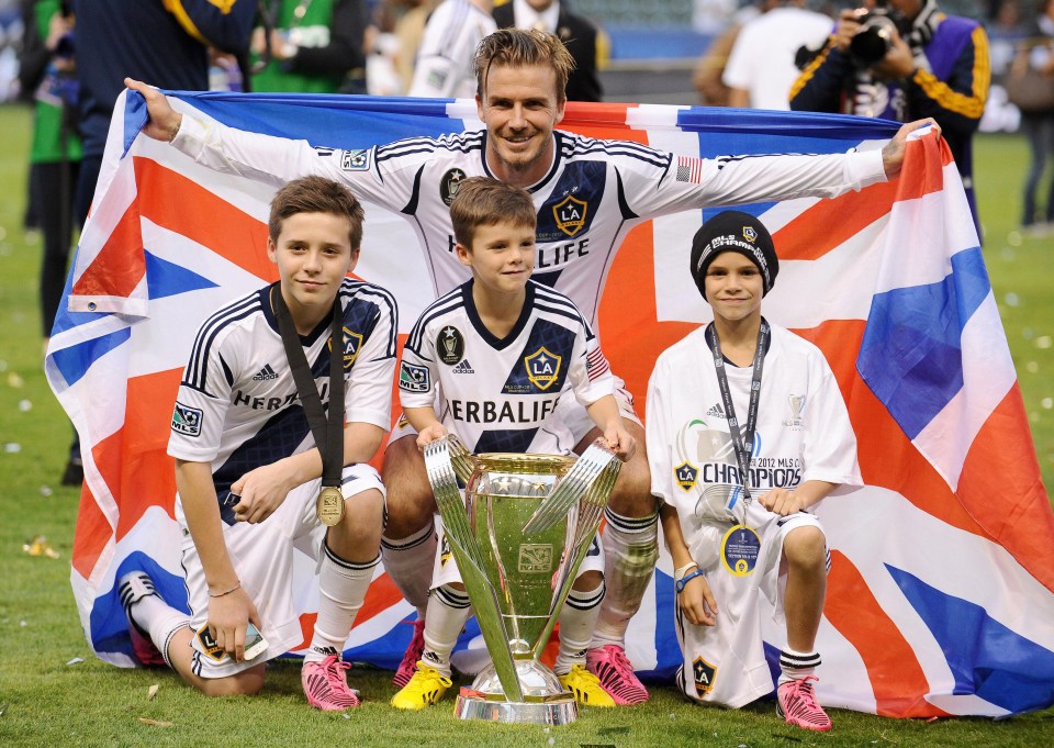 David Beckham poses with his sons (left to right) Brooklyn, Cruz and Romeo in 2013