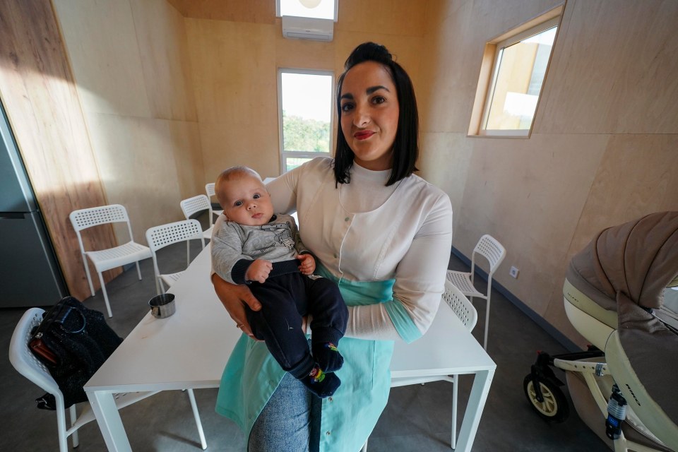 Nurse Vira Nazarevych, 28, holding four-month-old baby Daniil