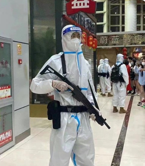 An armed Chinese policeman preventing passenger leaving an airport