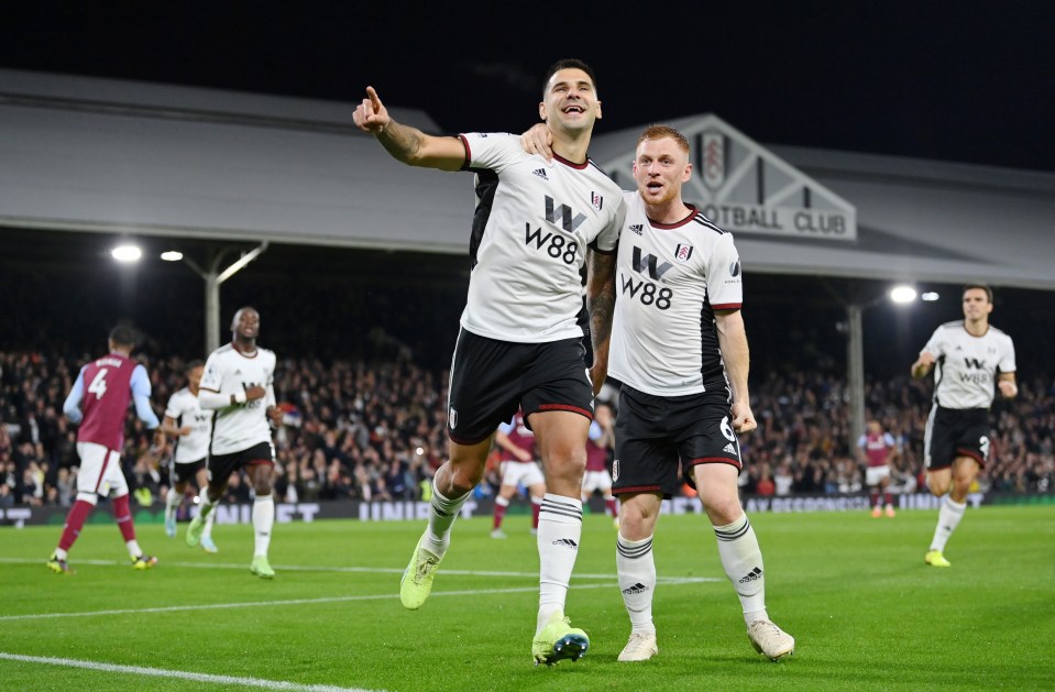 Aleksandar Mitrovic celebrates with Fulham's opening scorer Harrison Reed after making it 2-0 from the spot