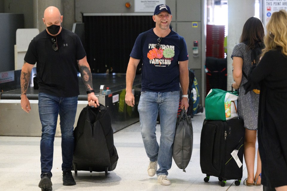 Rugby hero and royal Mike Tindall - wearing a baseball cap - pictured after landing in Australia