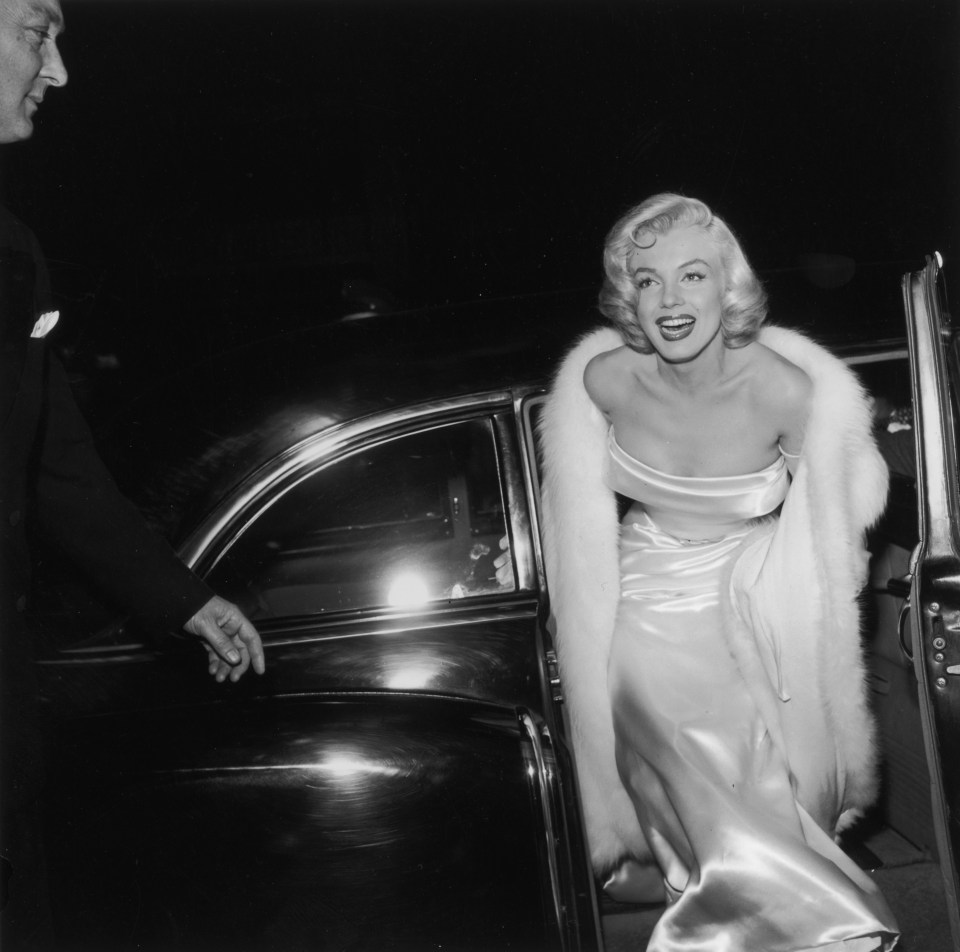 Marilyn Monroe shows off her curvaceous figure and blonde curls at the premiere of director Walter Lang’s film There’s No Business Like Show Business