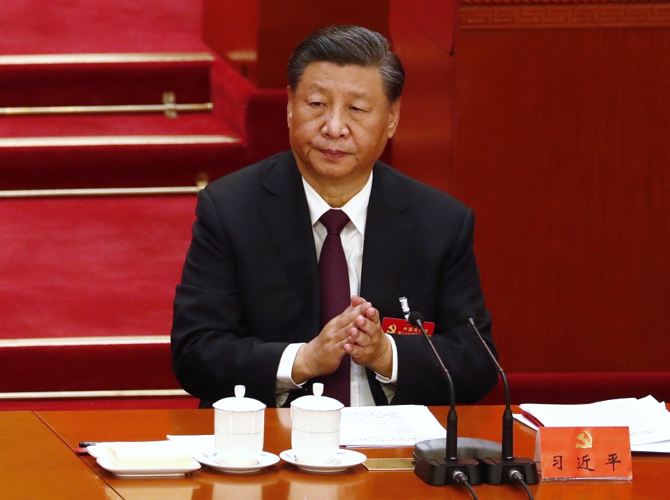 Hu was sat on stage next to successor Xi Jinping before two stewards led him out of the hall in Beijing