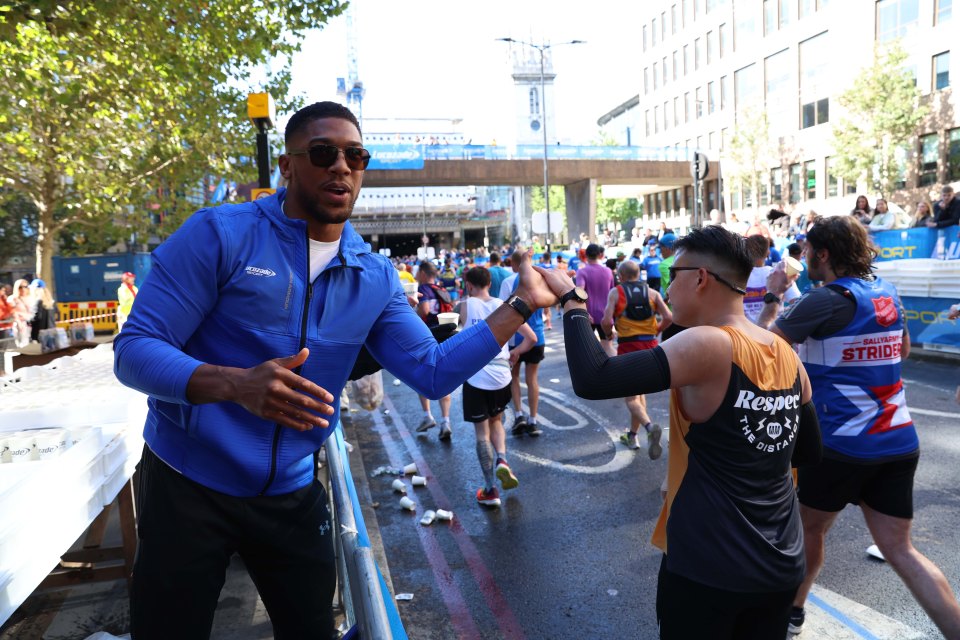 Anthony Joshua was handing out water to the runners