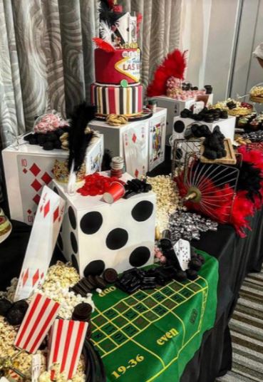 The food table was adorned with Vegas-themed decor including dice and cards