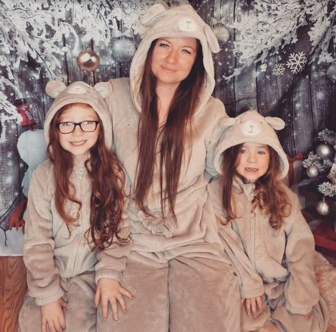 Shannon and her daughters in the onesies from Mrs Hinch's clothing range with Tesco