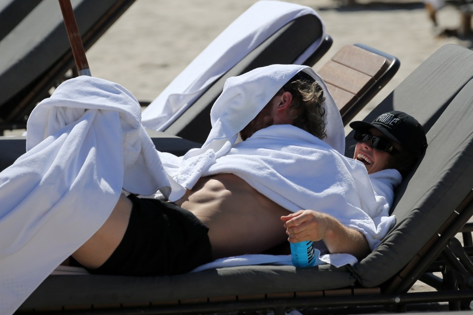 The pair briefly laughed while covering themselves with towels