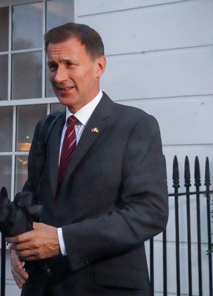 Jeremy Hunt pictured leaving his London home this morning ahead of a massive day in Westminster