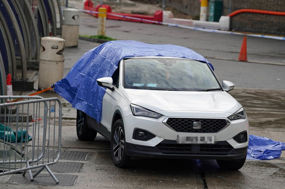 A white car was seen covered in a tarpaulin at the scene