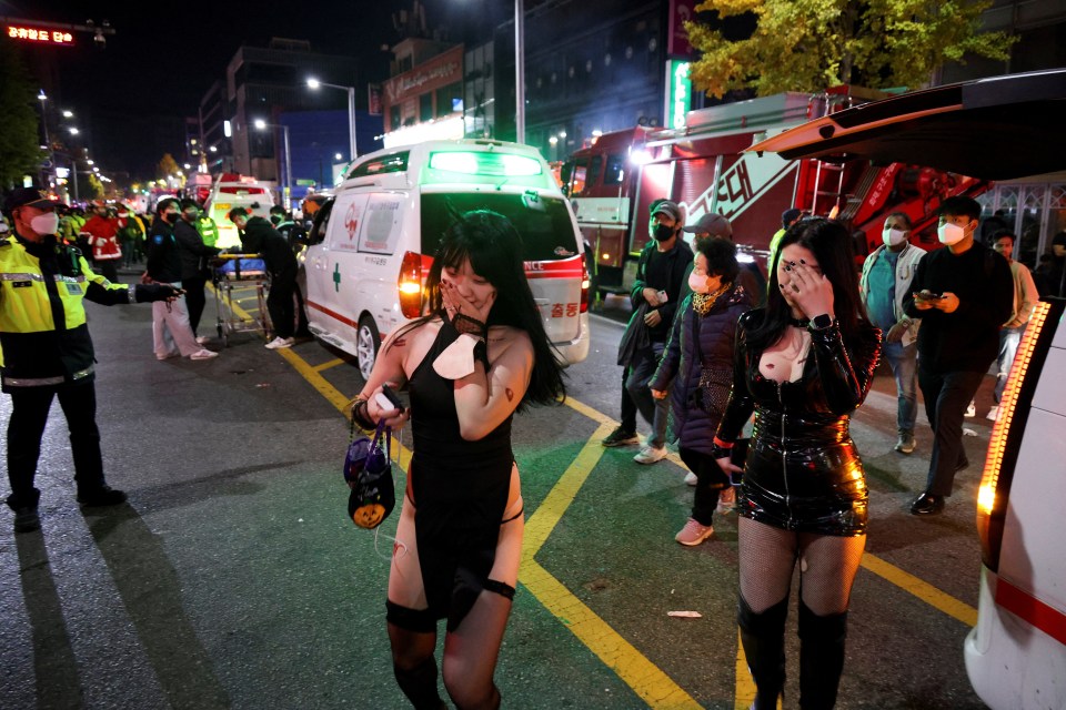 Shocked survivors leave the scene following the horror in Seoul on Saturday night