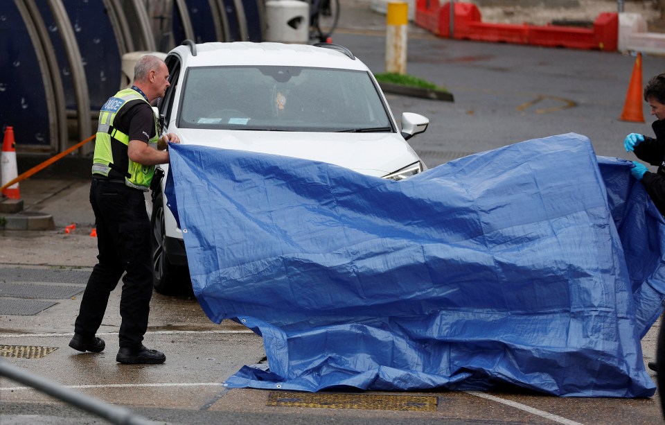 Cops covered a car - believed to be involved in the incident - with a tarpaulin