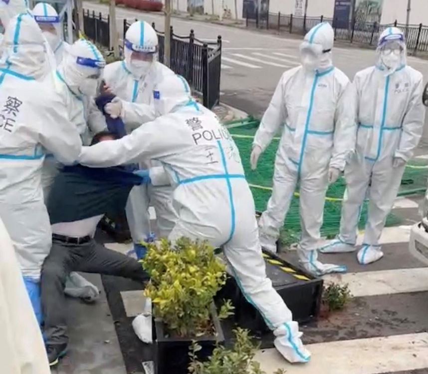 Police in hazmats move in to arrest a Covid lockdown violator in Shanghai