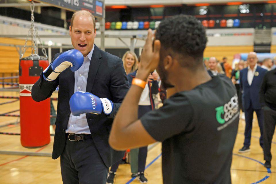 Prince William grinned as he got involved in a friendly boxing session