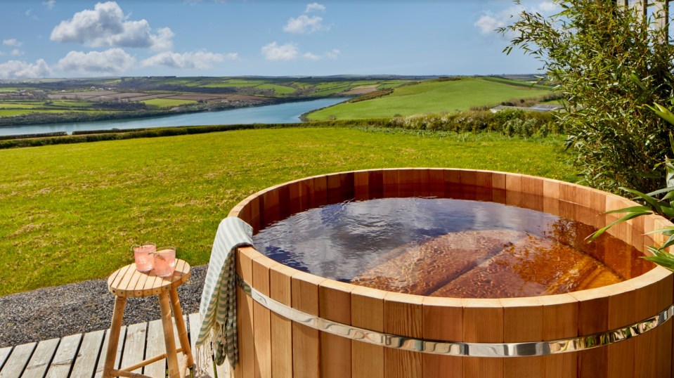 Outside, a hot tub overlooks the epic Cornish coastline