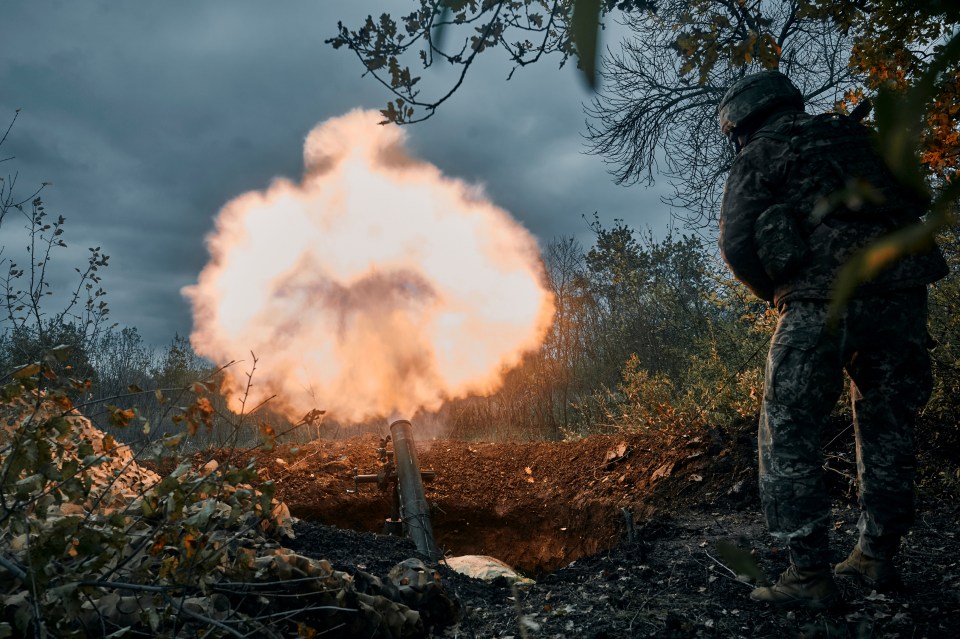 Ukrainian soldiers fire the Russian positions with the mortar in Bakhmut