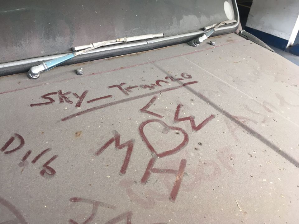 People leave their messages to the mystery owner written in dust