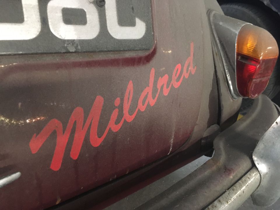 The name Mildred is painted in bright red letters