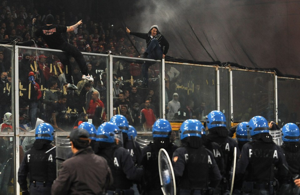 Authorities were forced to call off a Euros 2012 qualifier in Italy when fans tipped over barriers and stormed the pitch