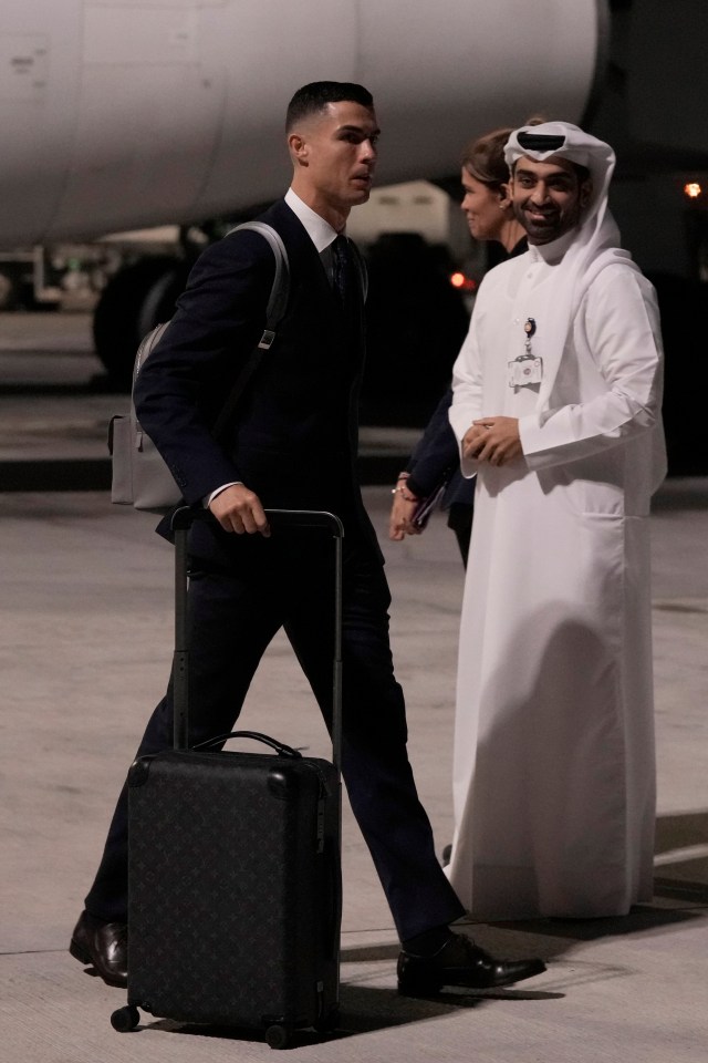 The star was suited and booted as he hit the tarmac in the Middle East