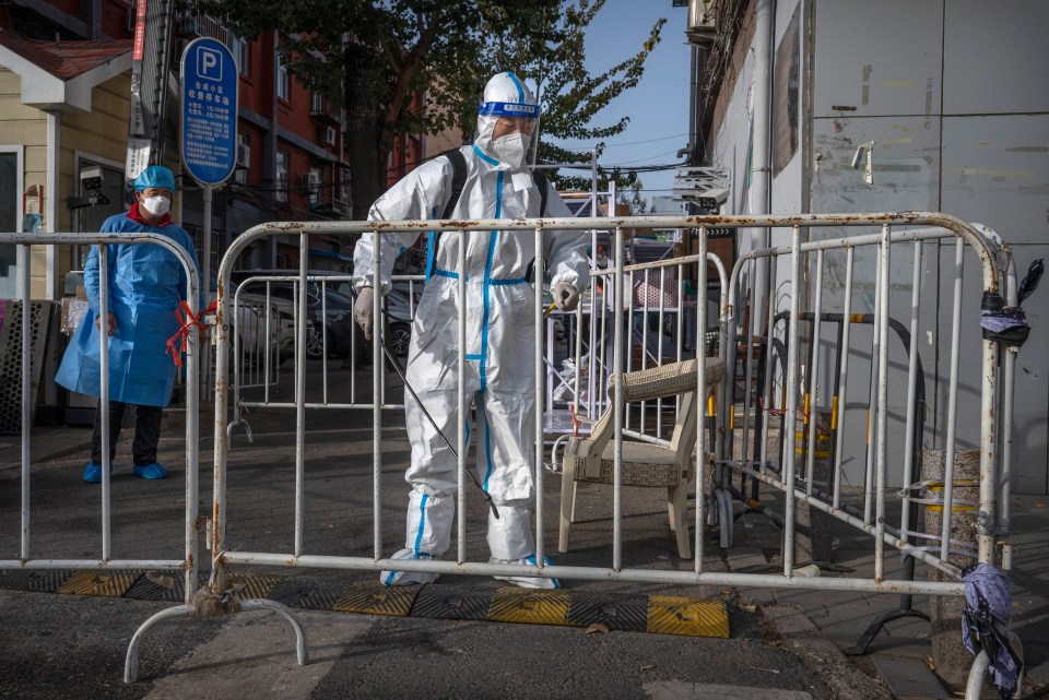 A hazmat-clad lockdown enforcer in Beijing