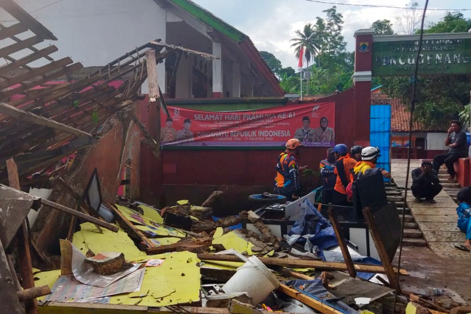 Rescuers inspect a school damaged by the earthquake in Cianjur