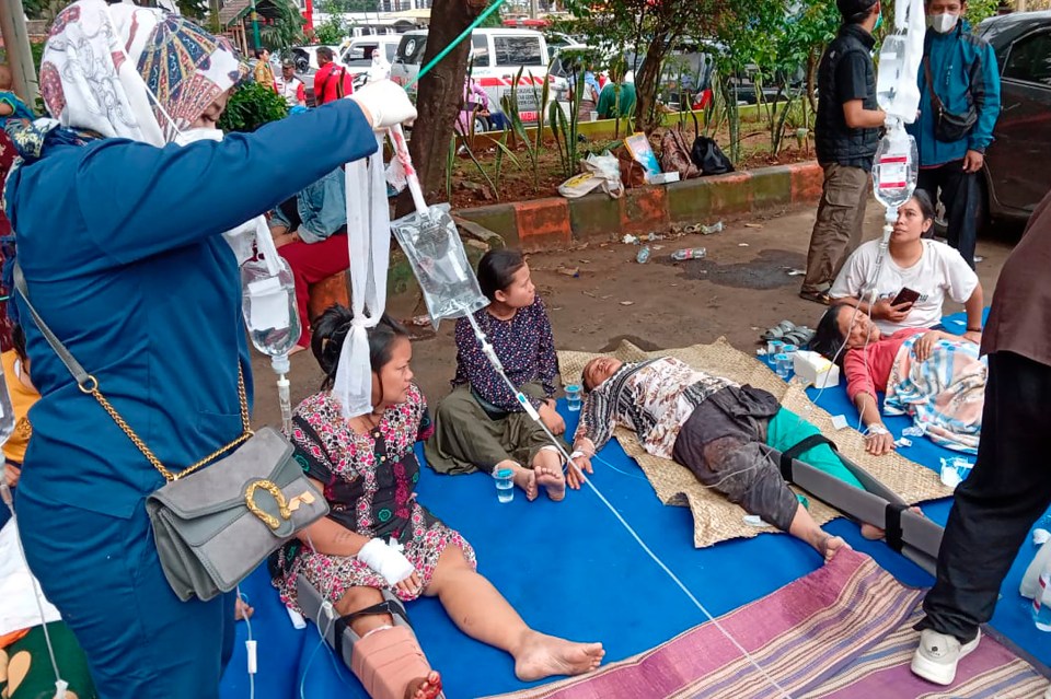 People injured during the quake receive medical treatment in a hospital car park