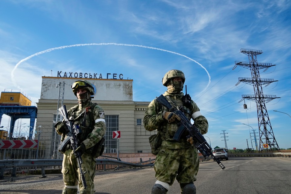 Russian troops guarding the Kakhovka Hydroelectric Station on the Moscow-controlled side of the Dnipro