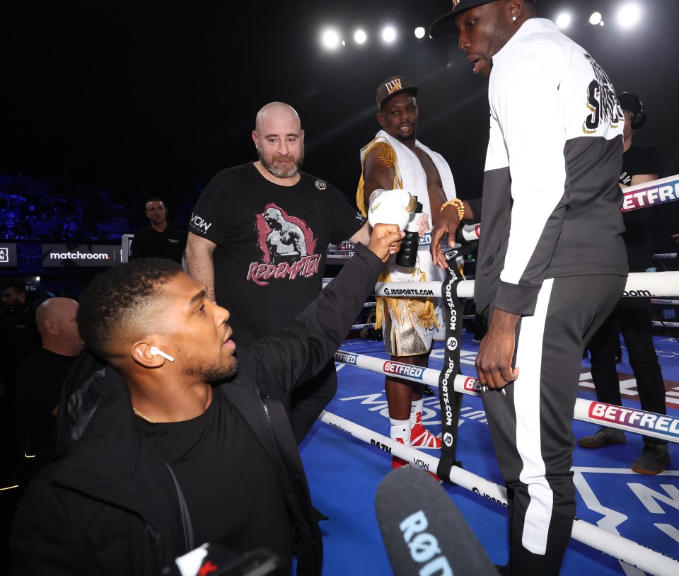 Anthony Joshua embraces with Dillian Whyte