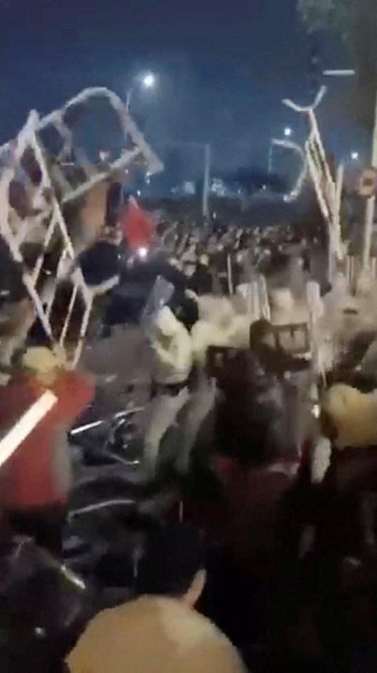 Workers hurl metal railings at cops in dramatic scenes