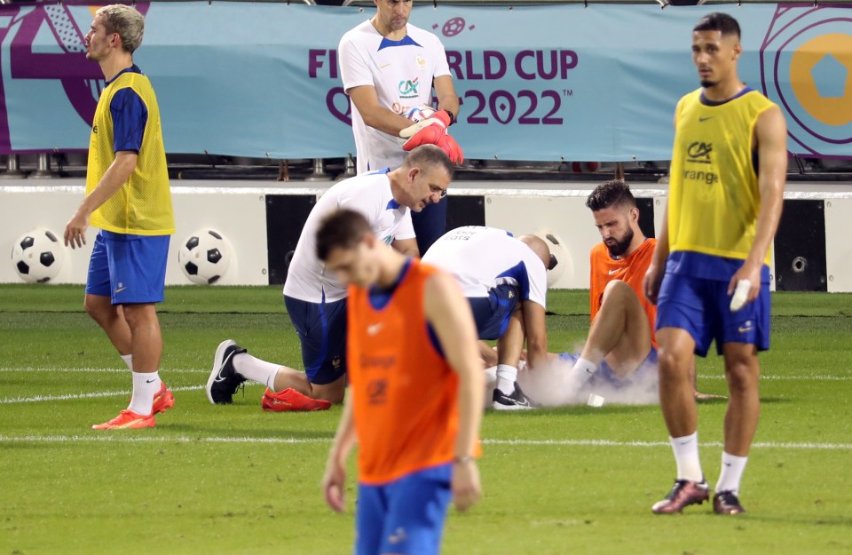 Olivier Giroud looks concerned as he gets treatment during training