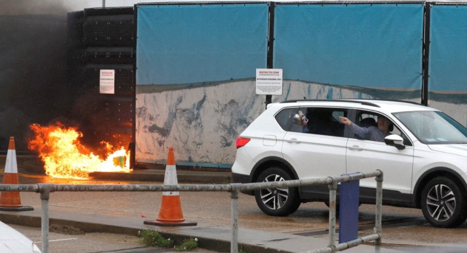 Andrew Leak hurls a petrol bomb out of the window of his car in the terror attack