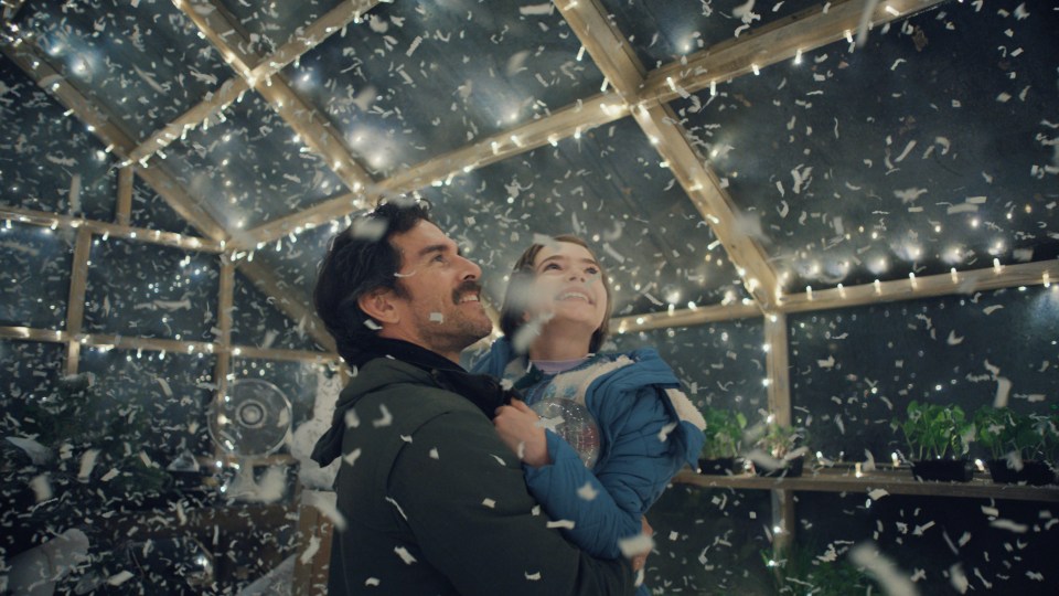 The father and daughter enjoy being in the Snow Globe